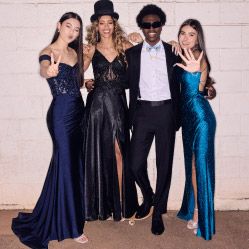 group of four prom goers posing