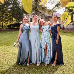 group of four bridesmaids in blue posing outside