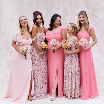 bridal party in pinks holding bouquets