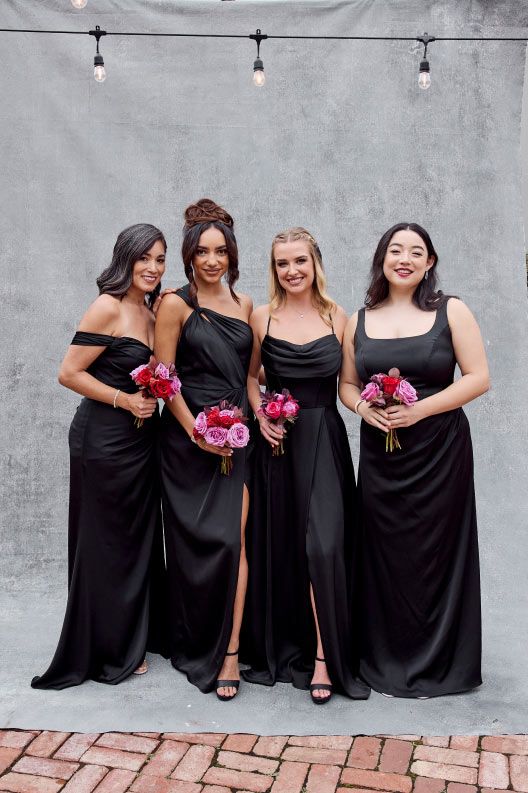 four bridesmaids in black holding bouquets