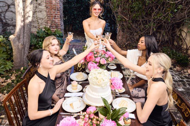 bridal party toasting at dinner table