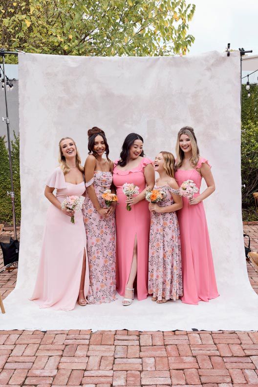 bridal party in pinks holding bouquets