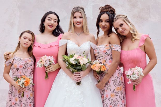 bridal party in pinks holding bouquets