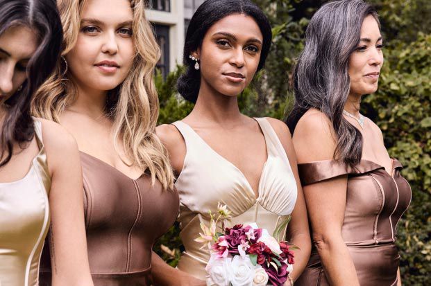 closeup of bridesmaids wearing neutral colored dresses