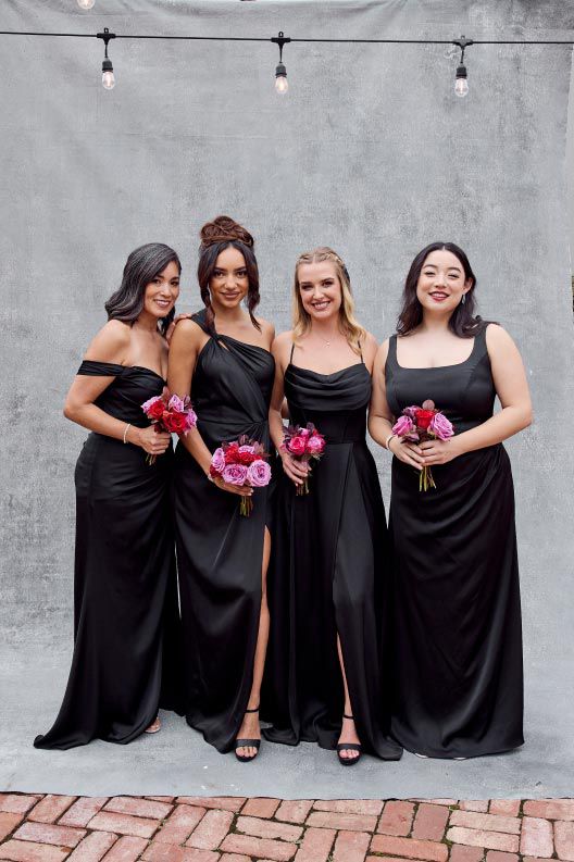 four bridesmaids in black holding bouquets
