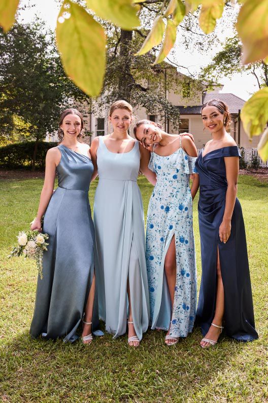 group of four bridesmaids in blue posing outside