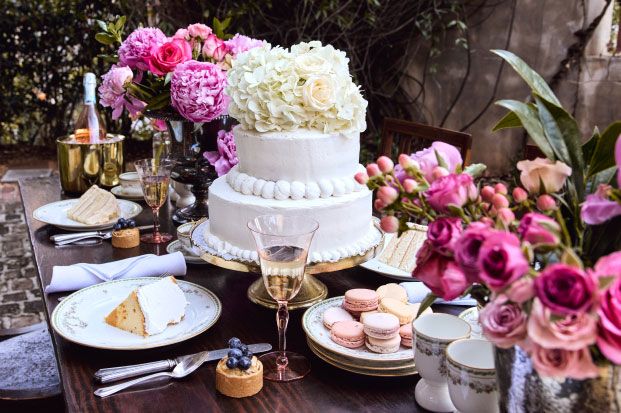 white wedding cake sitting on a decorated dinner table