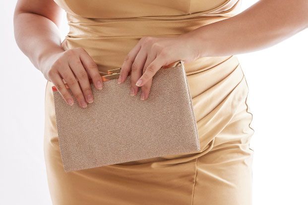 closeup of a bridesmaid holding a handbag