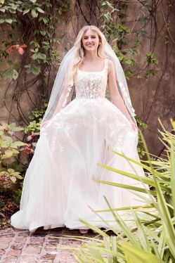 woman wearing a wedding dress in a garden