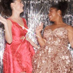 two girls in homecoming dresses laughing
