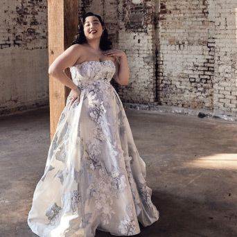 woman in floral print wedding dress posing in a warehouse