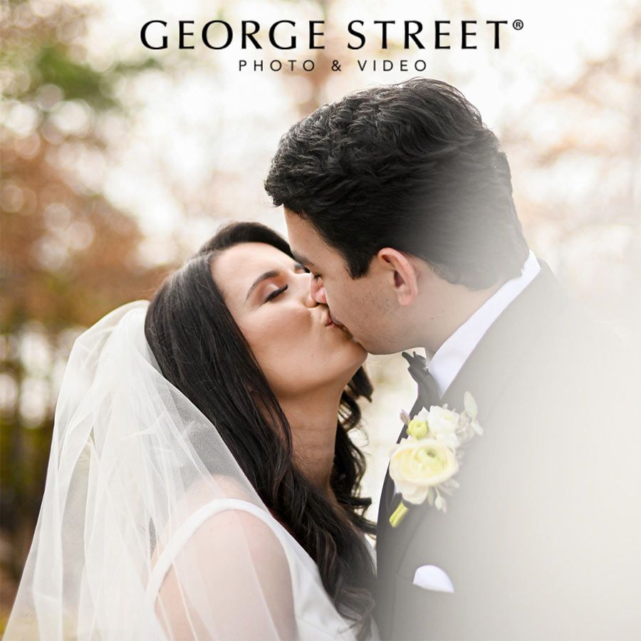 groom kissing bride promoting george street photo & video