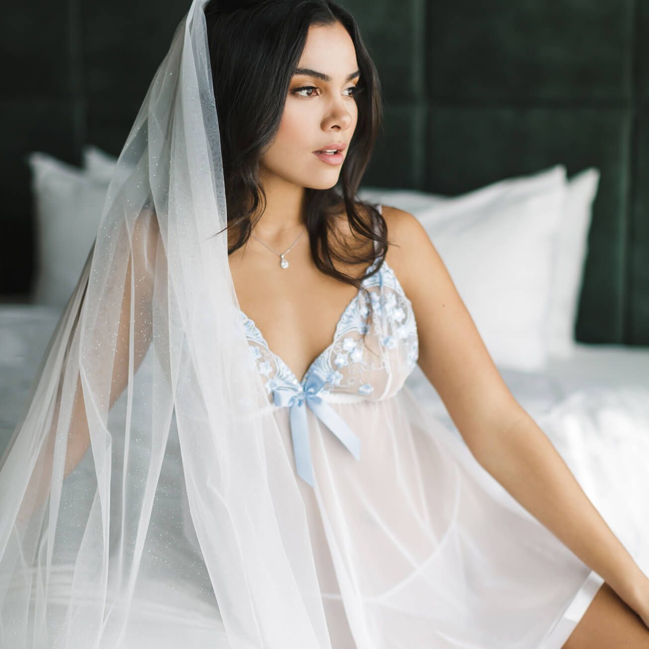woman in lingerie sitting on a bed
