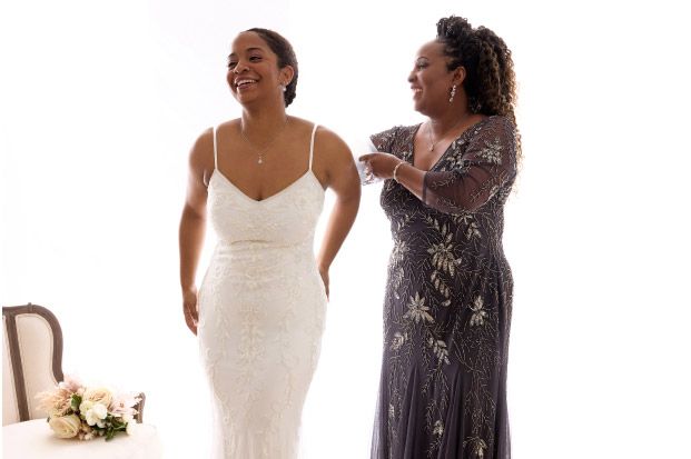 bride with her mother laughing and getting ready for the big day