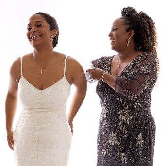 mother of bride adjusting her daughters veil