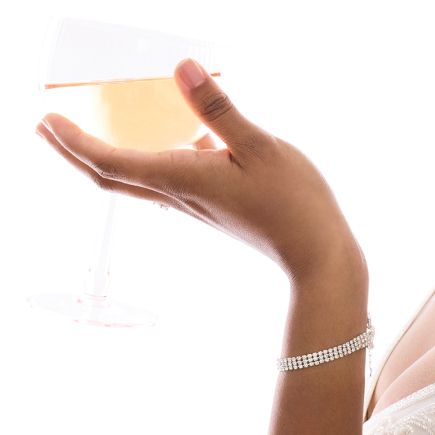 closeup of a hand holding a champagne glass