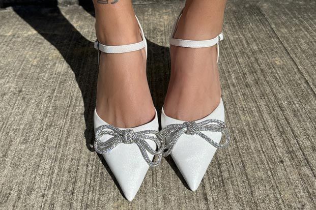 closeup of bridal shoes with sparkly bows