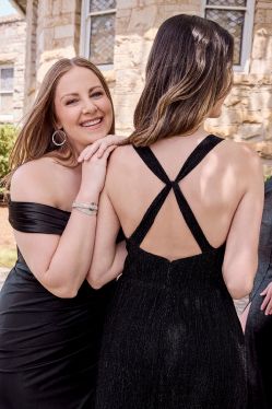 3 women in black bridesmaid dresses
