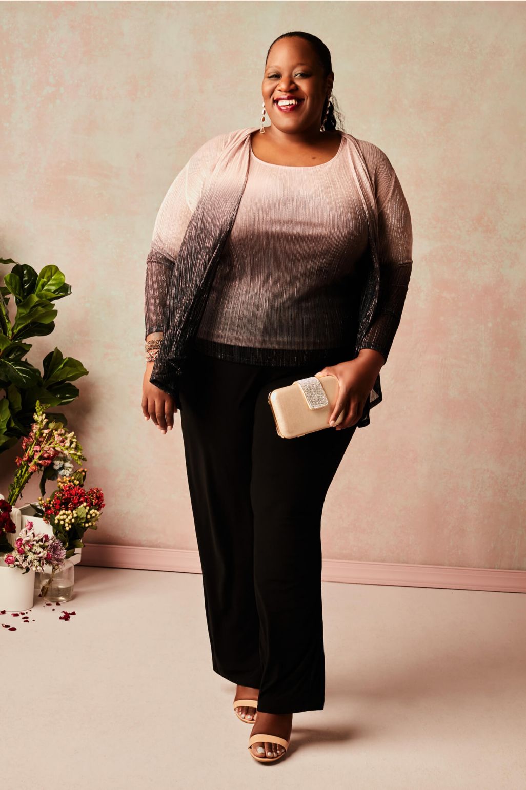 woman wearing pantsuit holding a handbag