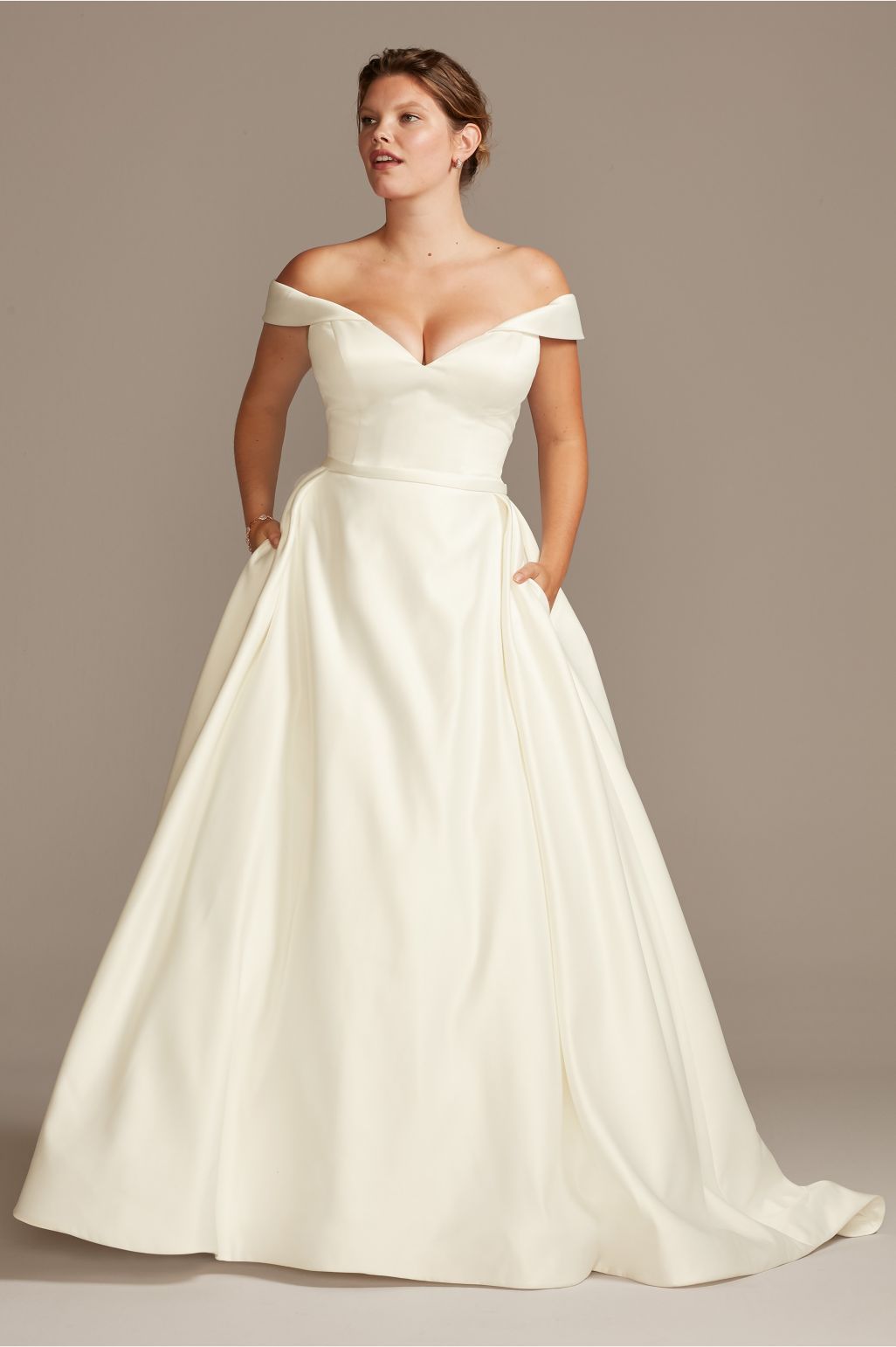 bride wearing wedding dress with hands in pockets