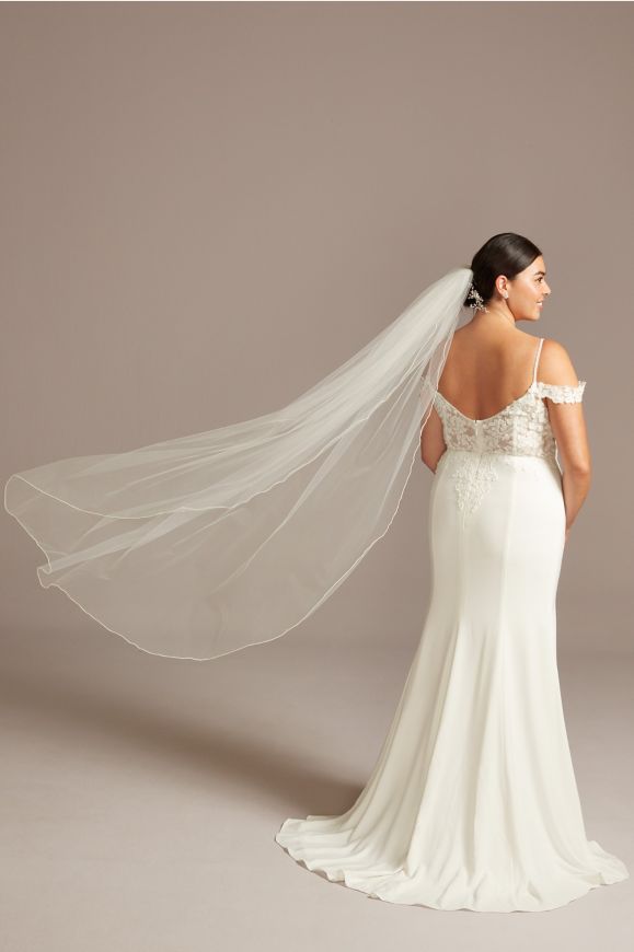 back of bride wearing a wedding dress showing off mid length veil