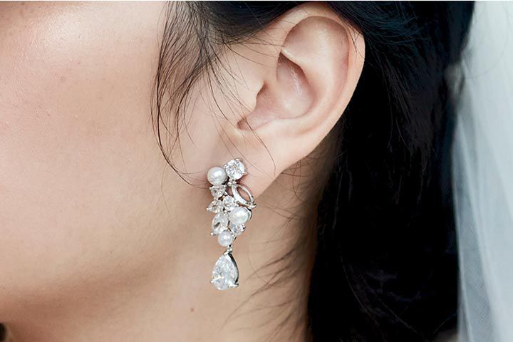 bride wearing pearl and crystal earrings