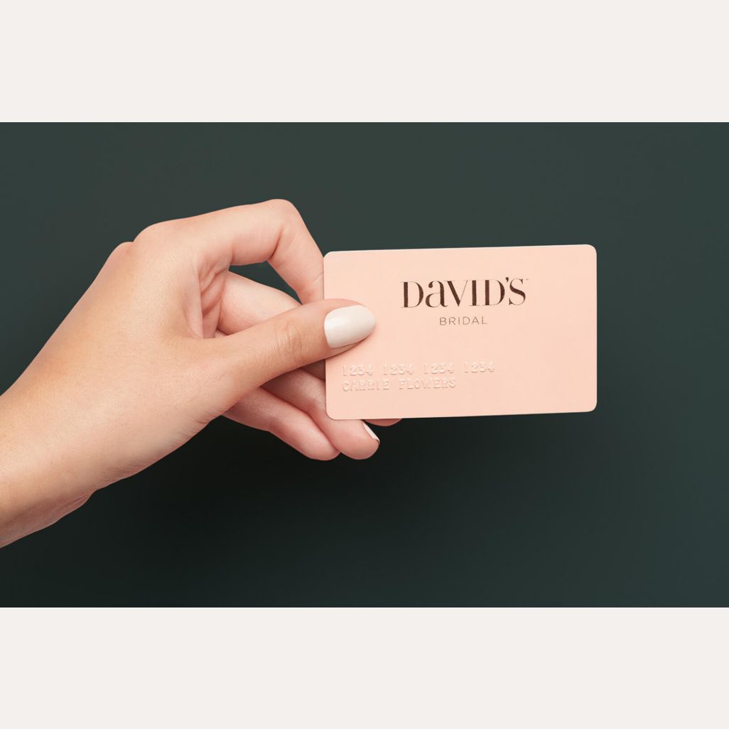 hand holding a david's bridal credit card