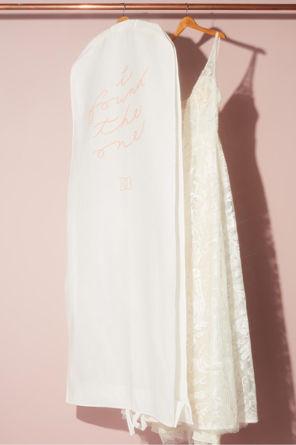 garment bag hanging on hanger next to dress