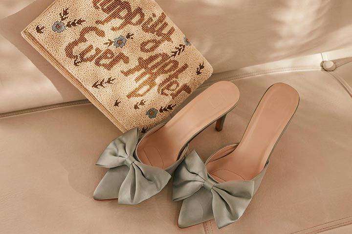 pillow and shoes with ribbons on a couch