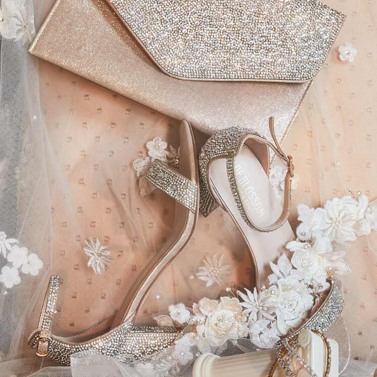 crystal embellished clutch and shoes against a lace fabric background