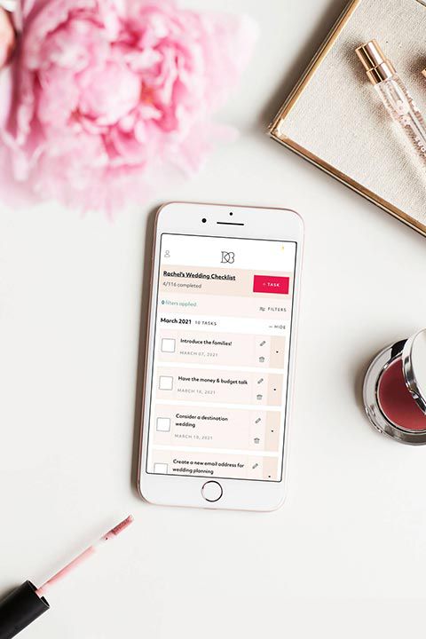 phone on table displaying wedding checklist