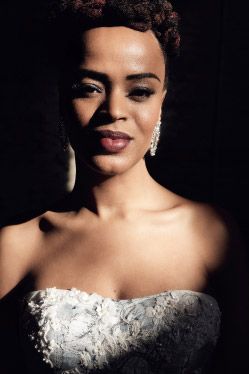 closeup of a woman in a wedding dress cloaked in shadow