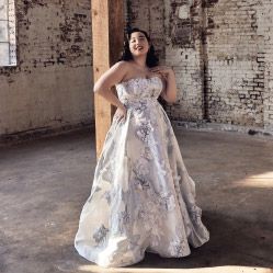 woman in print wedding dress leaning against a column