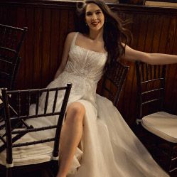woman in wedding dress surrounded by chairs