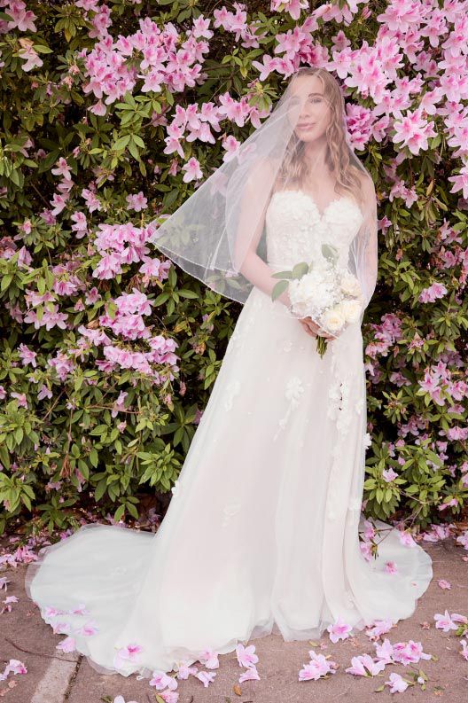 woman in bridesmaid dress standing in front of flowers
