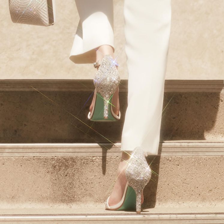 woman walking up steps in metallic stiletto shoes