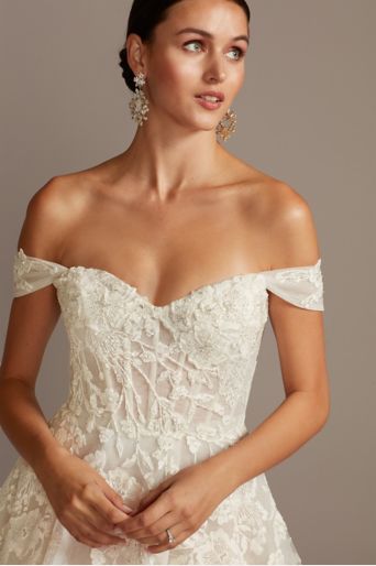 closeup of bride wearing a wedding dress with appliques and beading