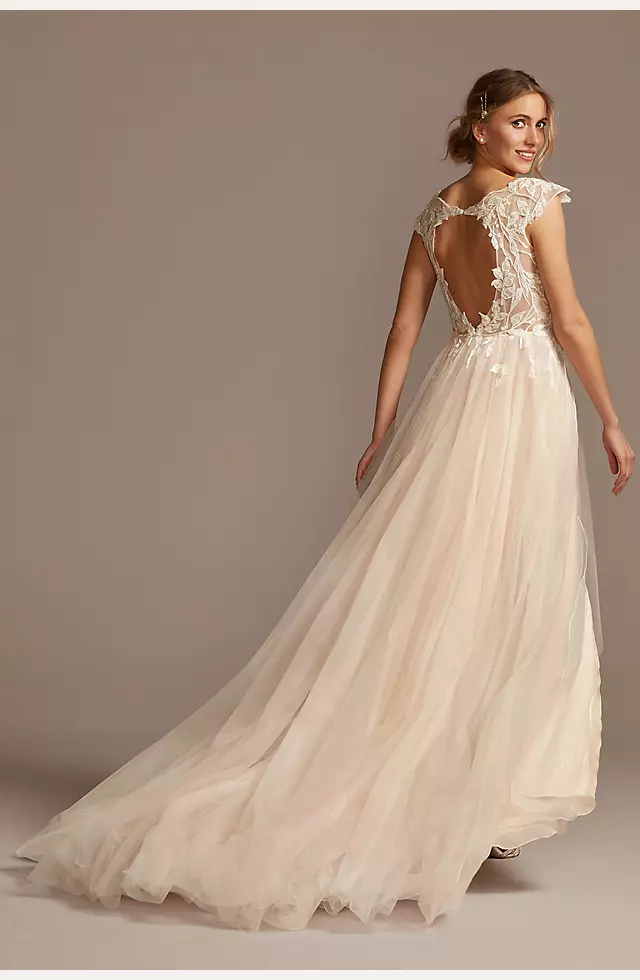 Cape sleeved wedding dress with illusion neckline and floral appliqué  across the bodice