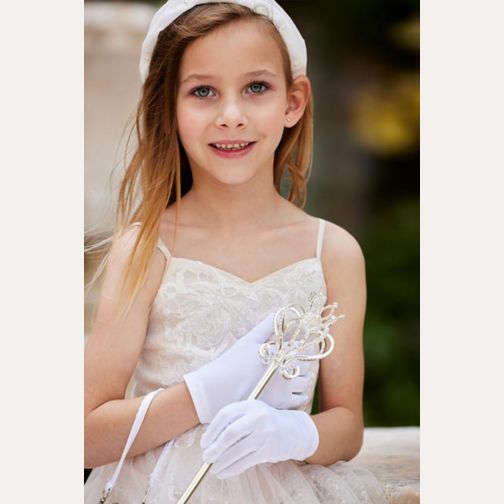 smiling flower girl wearing a headband and white gloves