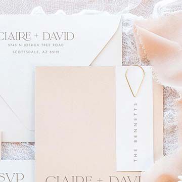 wedding invitation envelope on top of lace