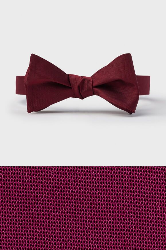 wine colored bow tie on top of a wine colored fabric swatch